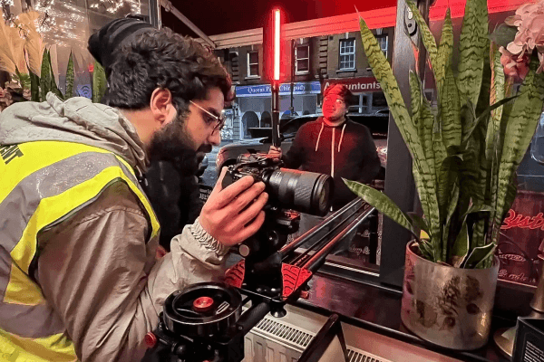 Cinematographer frames documentary shot with prime lens.