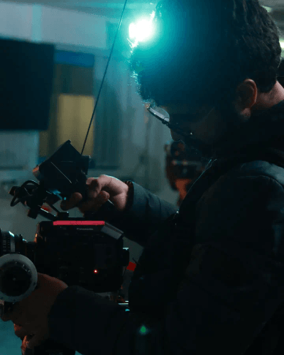 Cinematographer framing backlit subject, intense close-up shot.