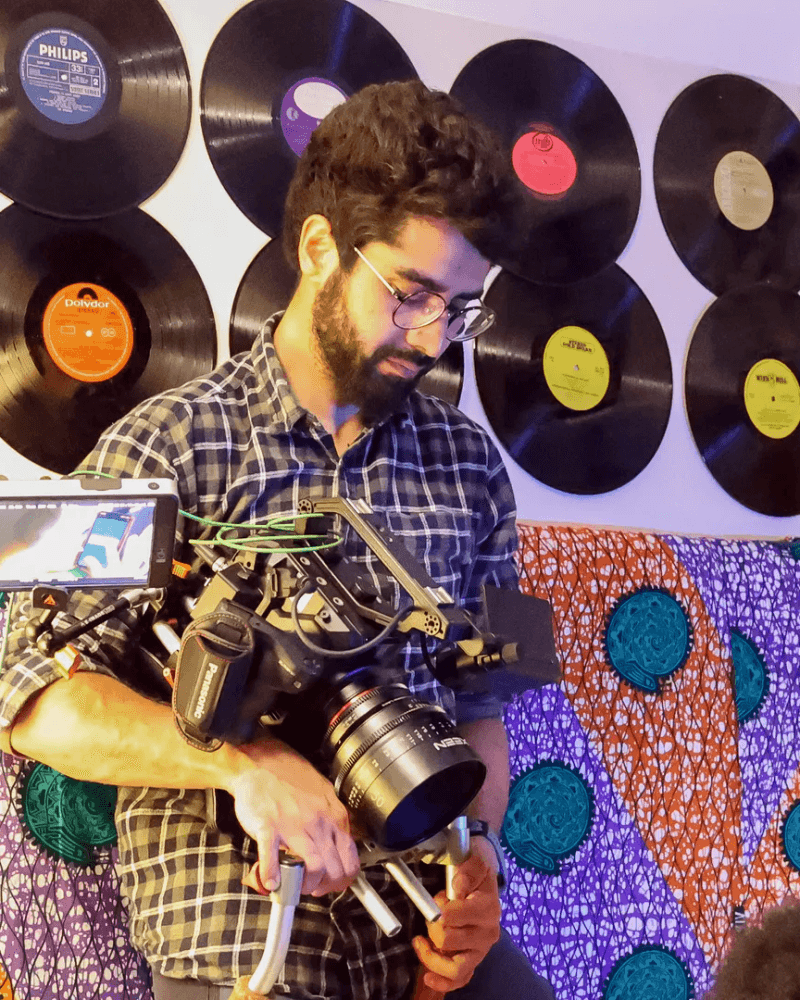 Rooh Yaseen, Director of Photography operating camera rig in warm cinematic light.